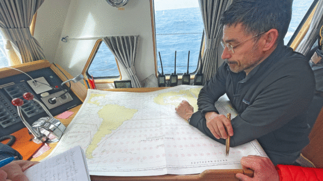 Skipper Kenneth Perdigón studies the chart