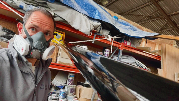 Someone in a mask working on a boat